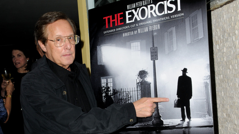 William Friedkin with Exorcist poster