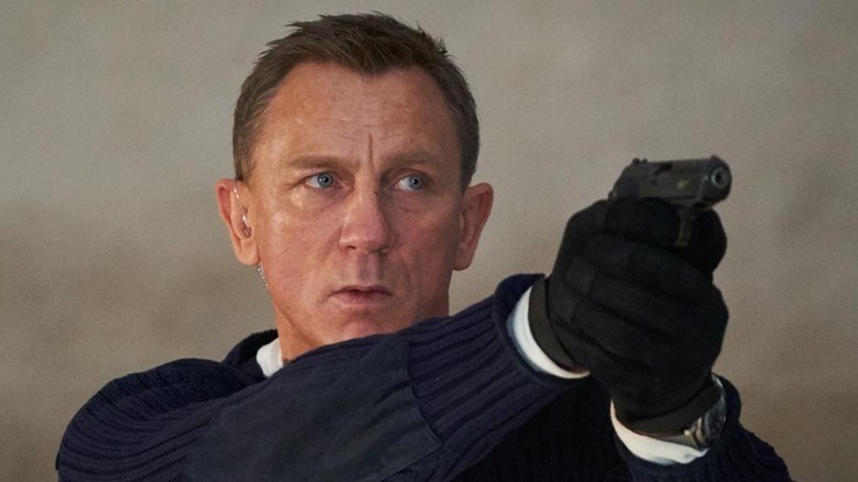 Daniel Craig as James Bond holding gun