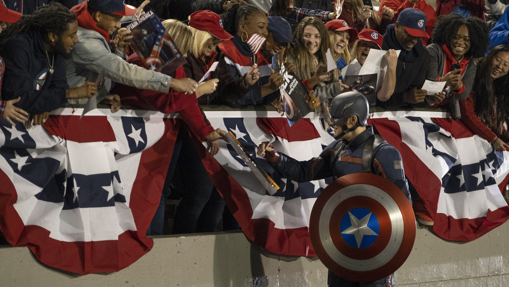 John Walker signs autographs at football game