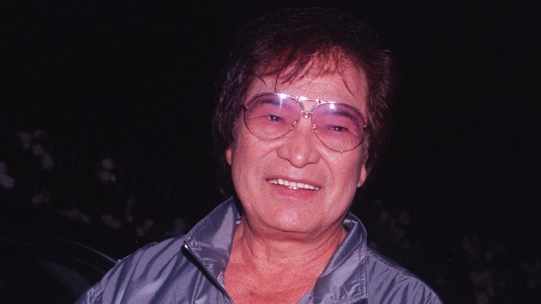 Don Ho beams while wearing glasses