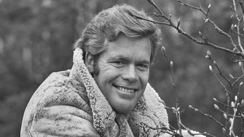 Doug McClure smiles while wearing heavy winter coat