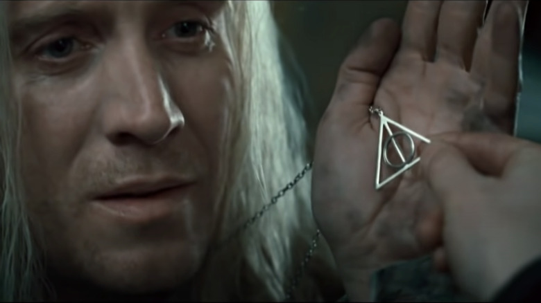 Xenophilius Lovegood with the Deathly Hallows symbol