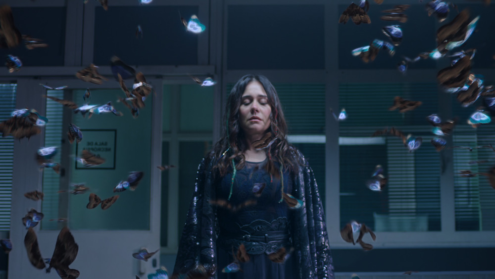 Ines surrounded by butterflies in police station