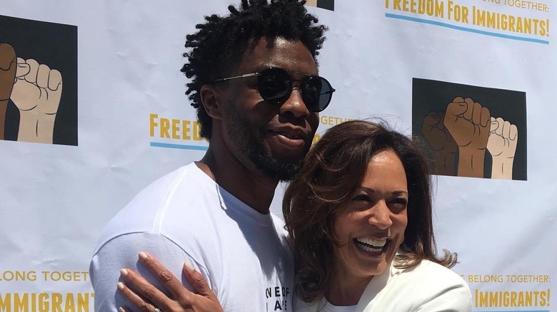 Chadwick Boseman holding Kamala Harris