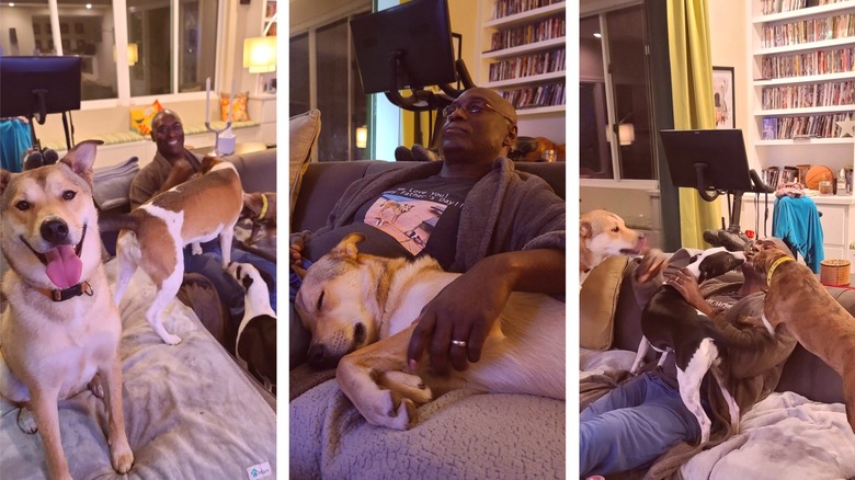 Lance Reddick sitting with dogs