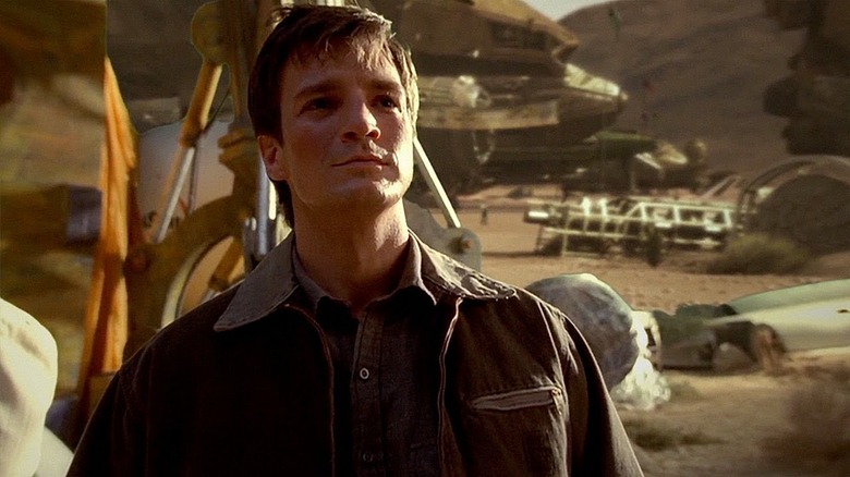 Firefly character Mal looking at spaceship