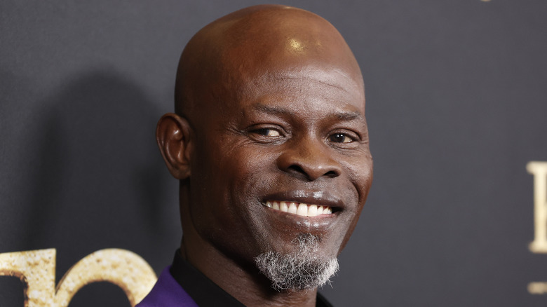 Hounsou in a purple suit