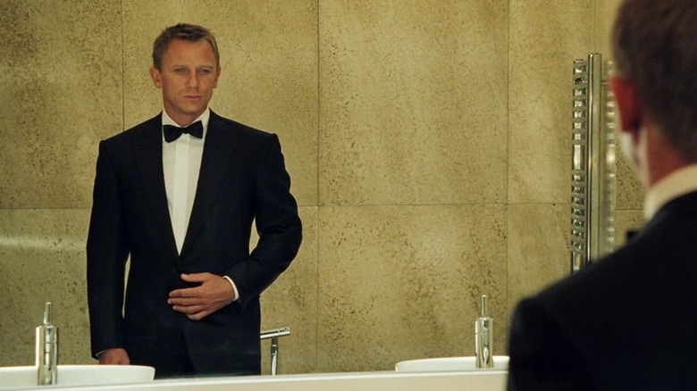 Bond examines himself in the mirror