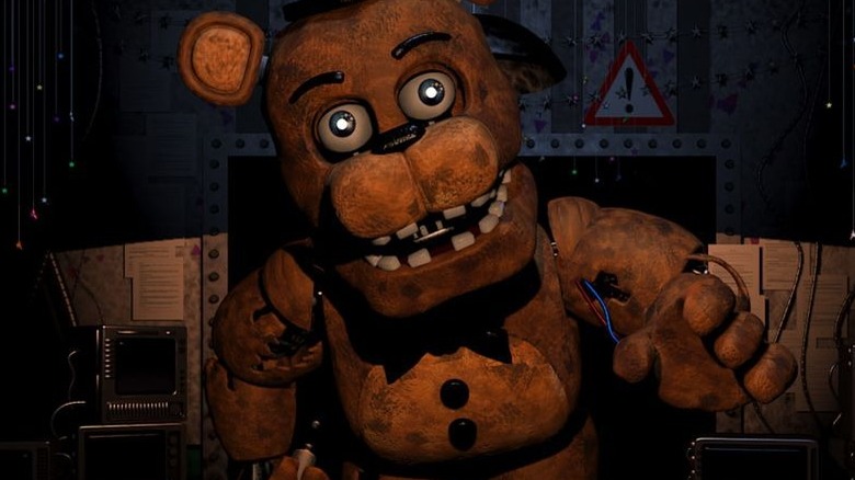 Freddy reaching toward night guard