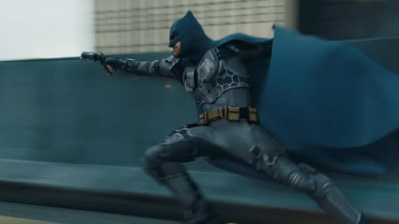 Batman deploys his grappling gun