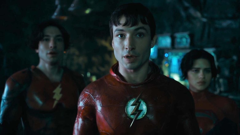 Flash standing in front of another Flash and Supergirl