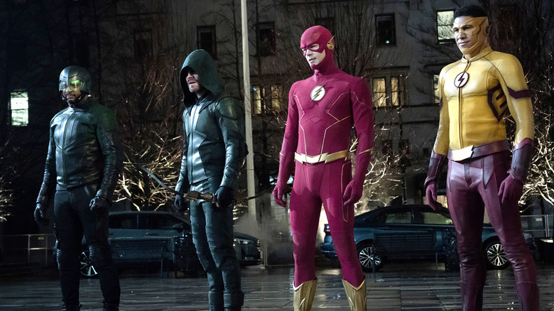 Diggle, Green Arrow, Flash, and Wally West standing in street