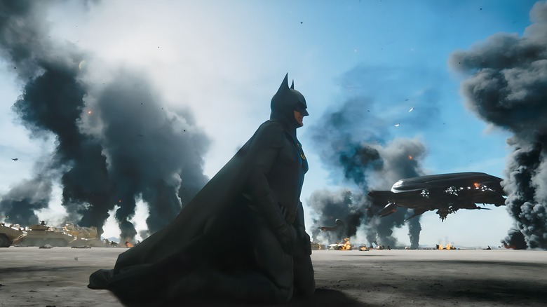 Batman walking on a battlefield