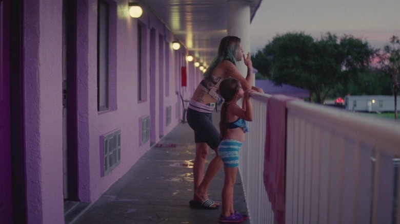 Halley and Moonee leaning on a motel's balcony railing