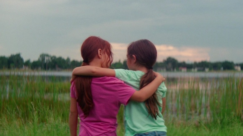 Moonee and Jancey hugging and gazing out at swampland