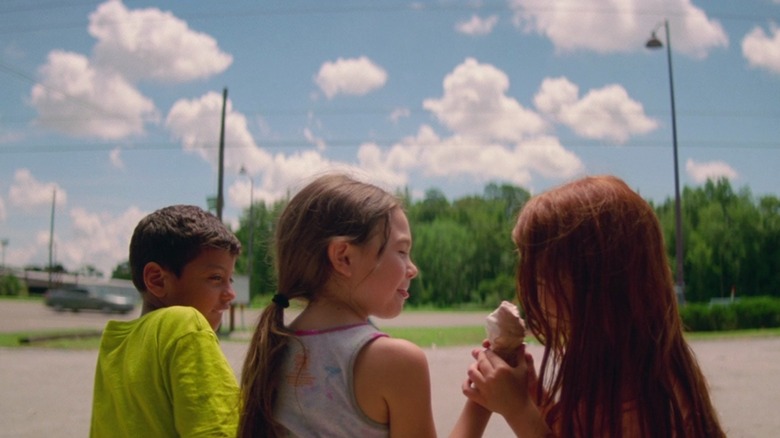 Scooty, Moonee, and Jancey sharing an ice cream cone in a parking lot