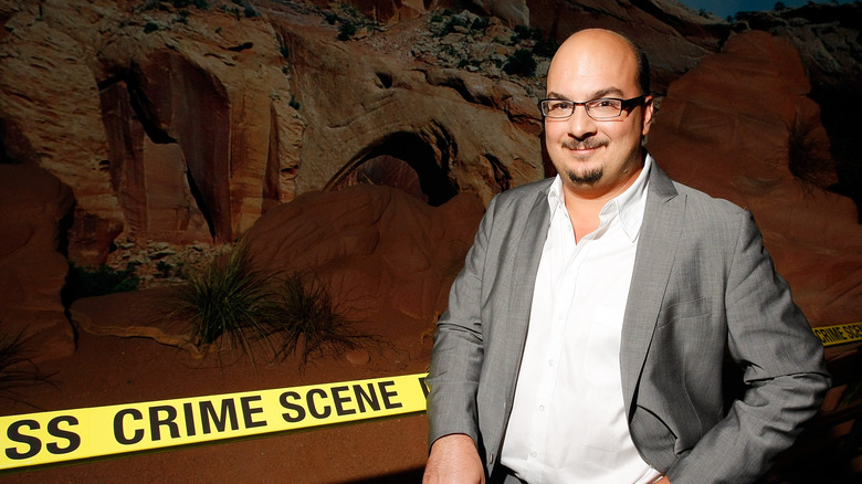 Anthony Zuiker standing next to a staged crime scene