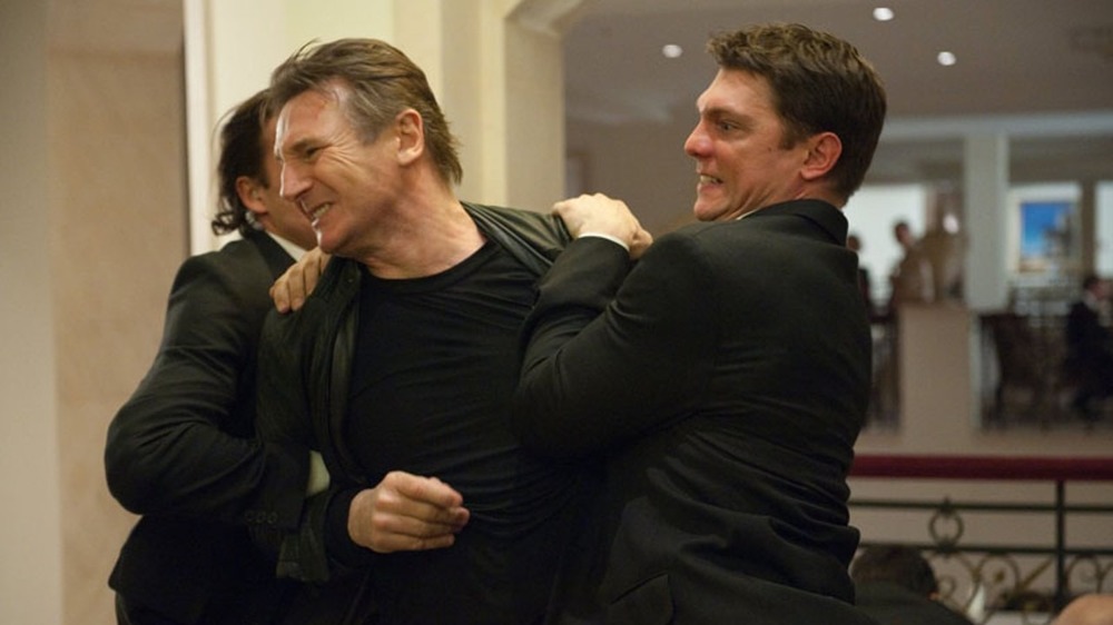 Liam Neeson gets dragged away