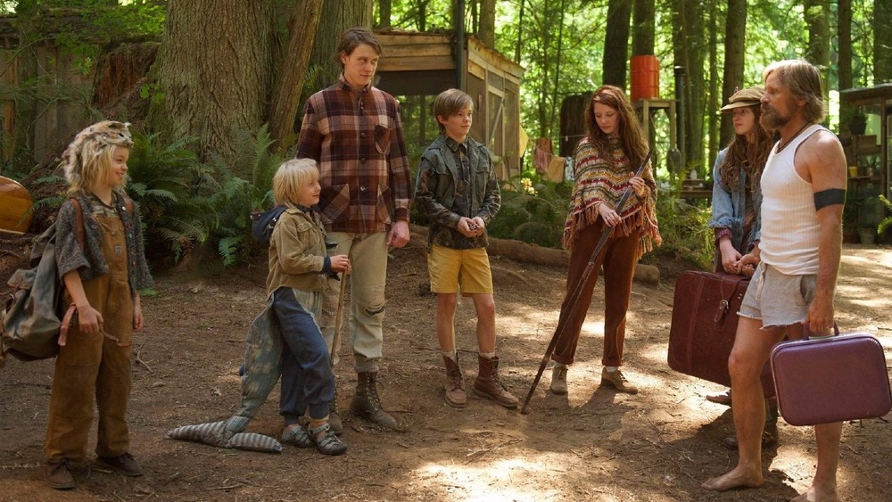 Ben and his six kids in woods with suitcases