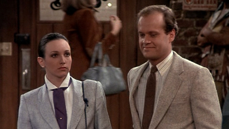 Frasier and Lilith stand by the bar at Cheers