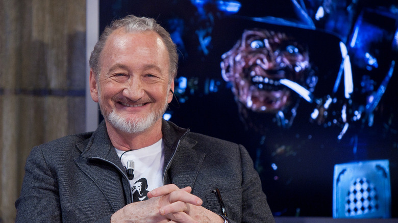 Englund smiling with Freddy in background