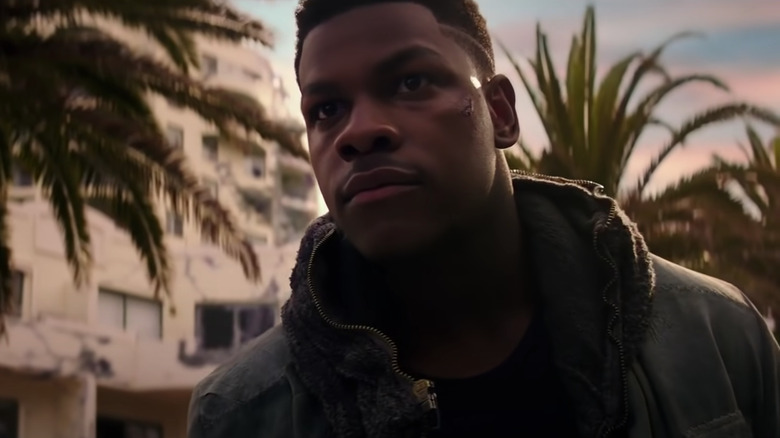 John Boyega in front of palm trees