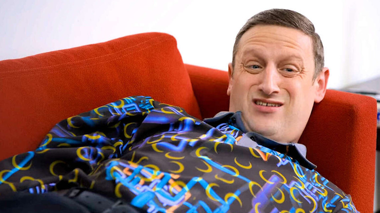 Tim Robinson wearing a brightly colored shirt