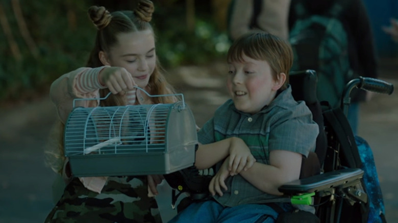 Chris Kimbreau and Evie smiling at gerbil cage