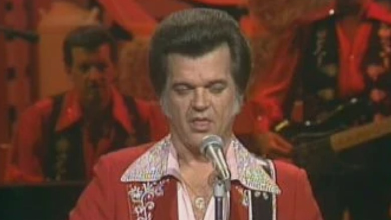 Conway Twitty performing on stage