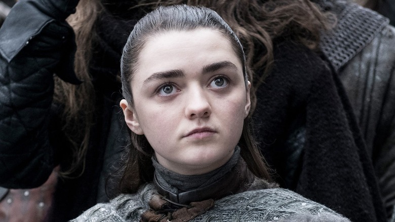 Arya Stark standing in crowd