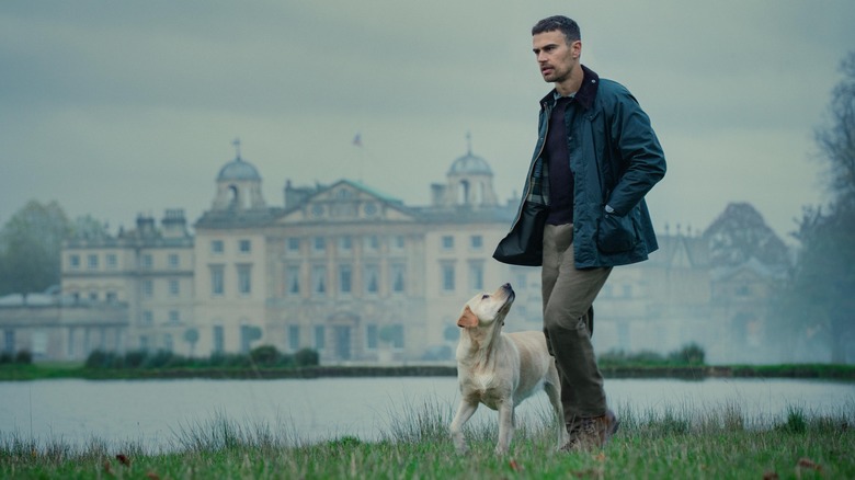 Edward walking on the grounds with dog