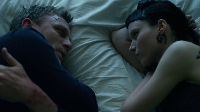 Craig and Mara facing each other on bed