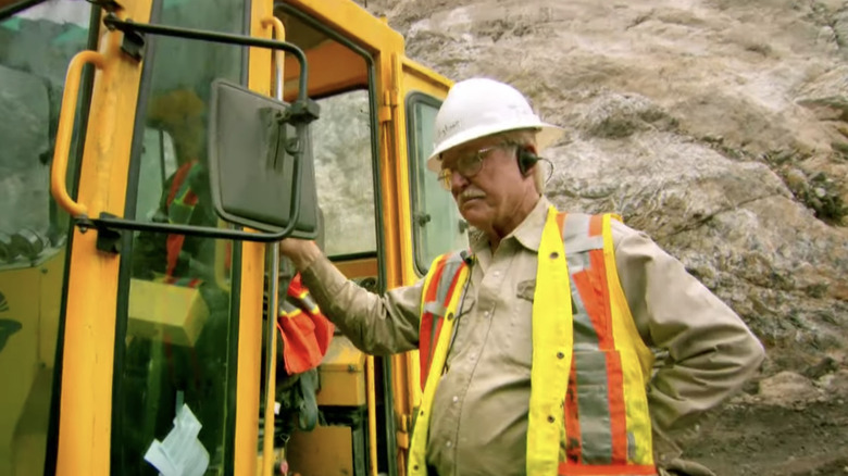 Fred Hurt stands beside a machine