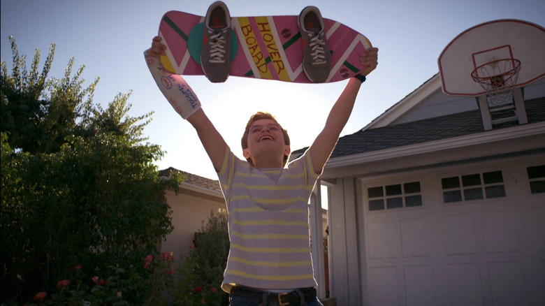 Adam Goldberg smiling with hoverboard