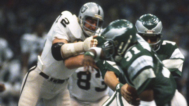 John Matuszak tackling Wilbert Montgomery