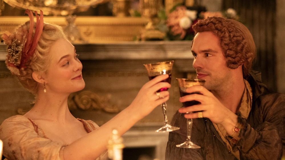 Elle Fanning and Nicholas Hoult toasting in The Great