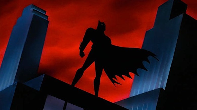 Batman's silhouette  against the red Gotham skyline