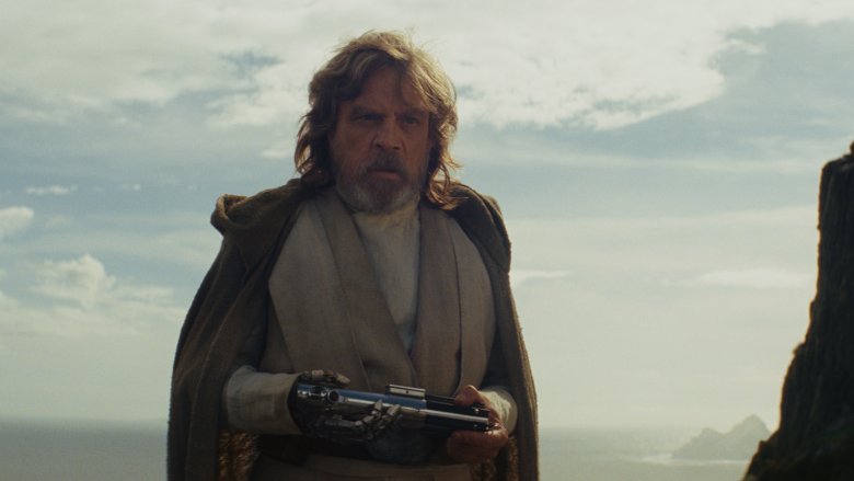 Luke Skywalker holds lightsaber