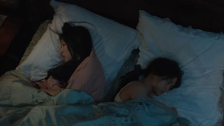 Hideko and Sook-hee awake in bed