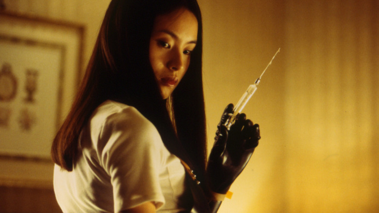 Asami holding large syringe