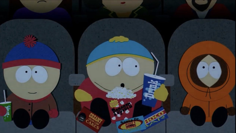 Stan, Cartman, and Kenny watch a movie in a movie theater.