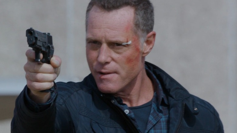 Jason Beghe holding gun in one hand