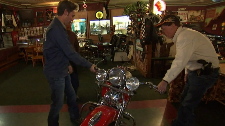 Mike Wolfe looking at a motorcycle