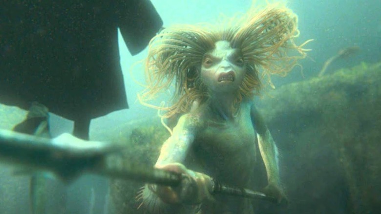 Merperson underwater trident