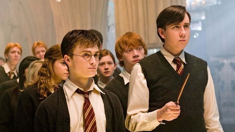 Harry Potter and Neville Longbottom standing