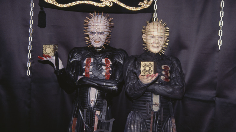 Pinhead posing next to a wax sculpture of himself