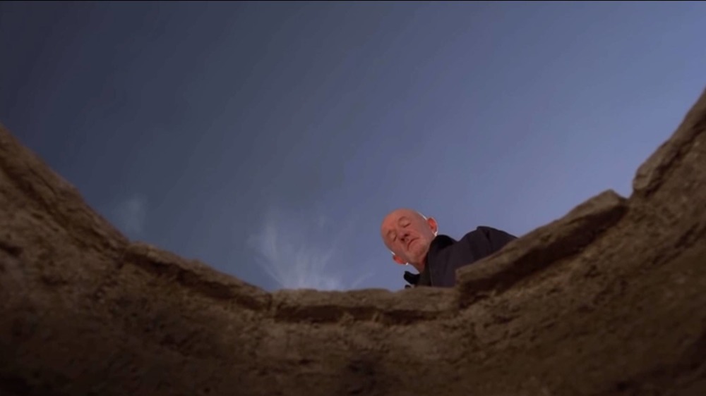 Breaking Bad Mike Ehrmantraut looks into a well