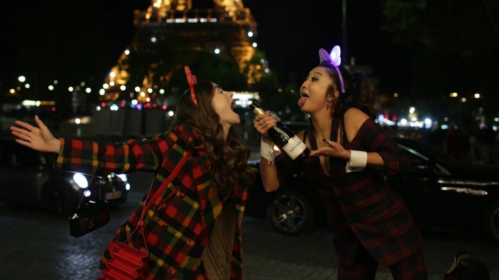 Lily Collins as Emily and Ashley Park as Mindy in Emily in Paris