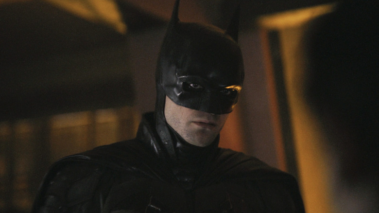 Robert Pattinson's Batman standing in apartment