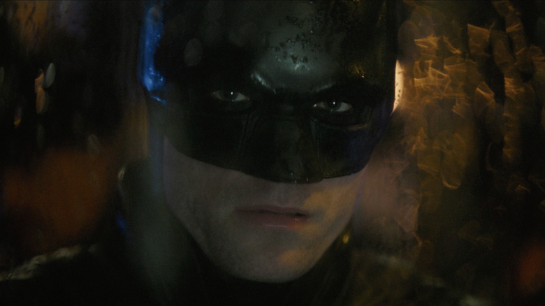 Batman looking through glass window